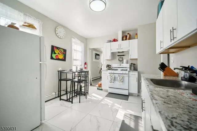 a kitchen with stainless steel appliances a stove a sink and a refrigerator