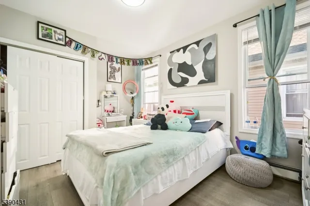 a bedroom with a bed and a painting on the wall