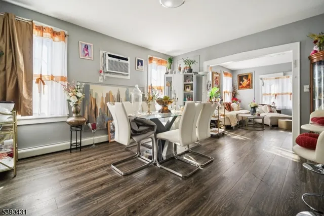 a living room with furniture a window and wooden floor