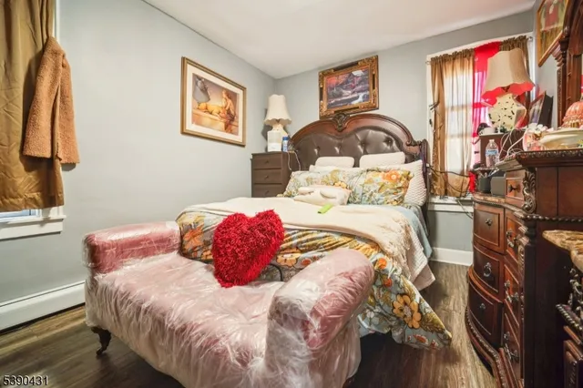 a bedroom with a bed and a painting on the wall