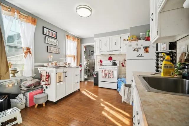 a living room with furniture and a kitchen view
