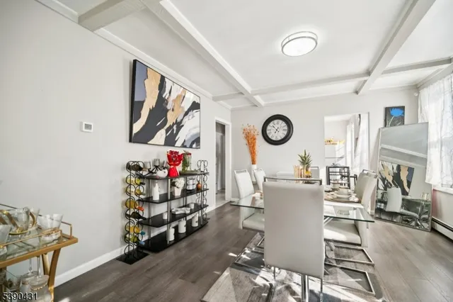 a living room with fireplace furniture and wooden floor