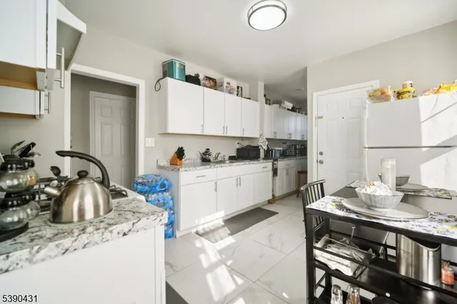 a kitchen that has a lot of cabinets in it and appliances