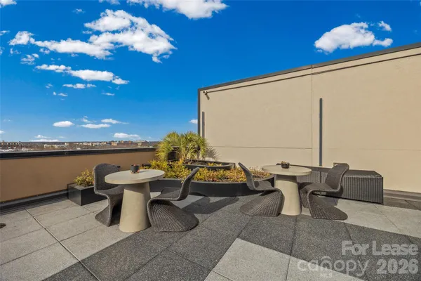 a building outdoor space with patio furniture and potted plants