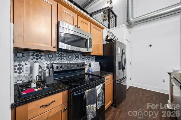 a kitchen with stainless steel appliances granite countertop a stove and a microwave