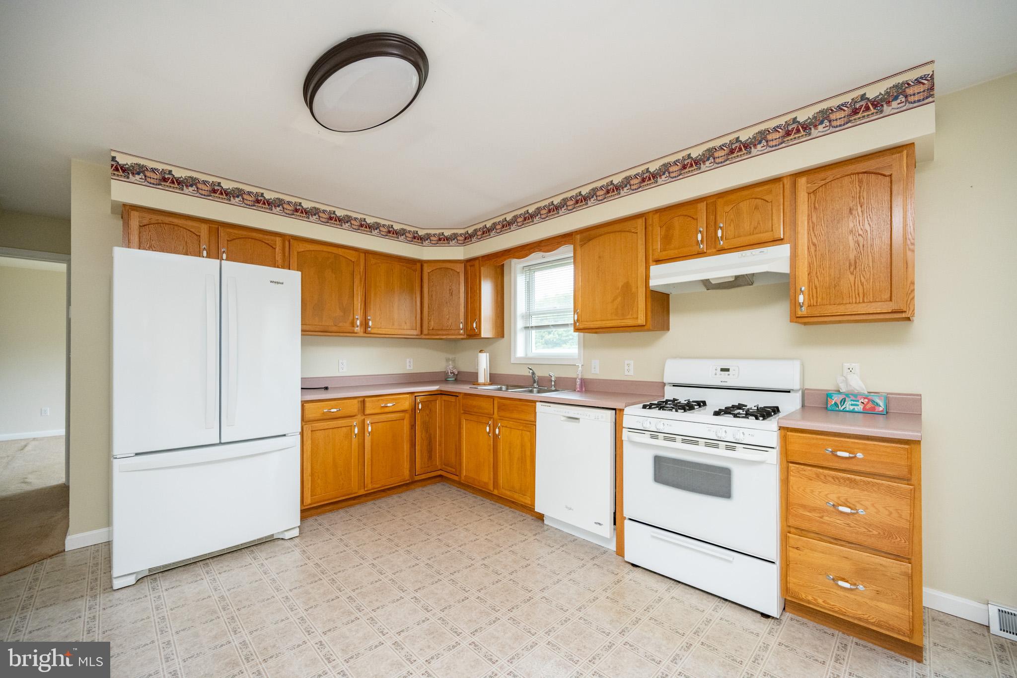386 Marlin Savage Road Accident, MD 21520 - Photo 33 of 63 a kitchen with stainless steel appliances granite countertop a stove a sink and a refrigerator