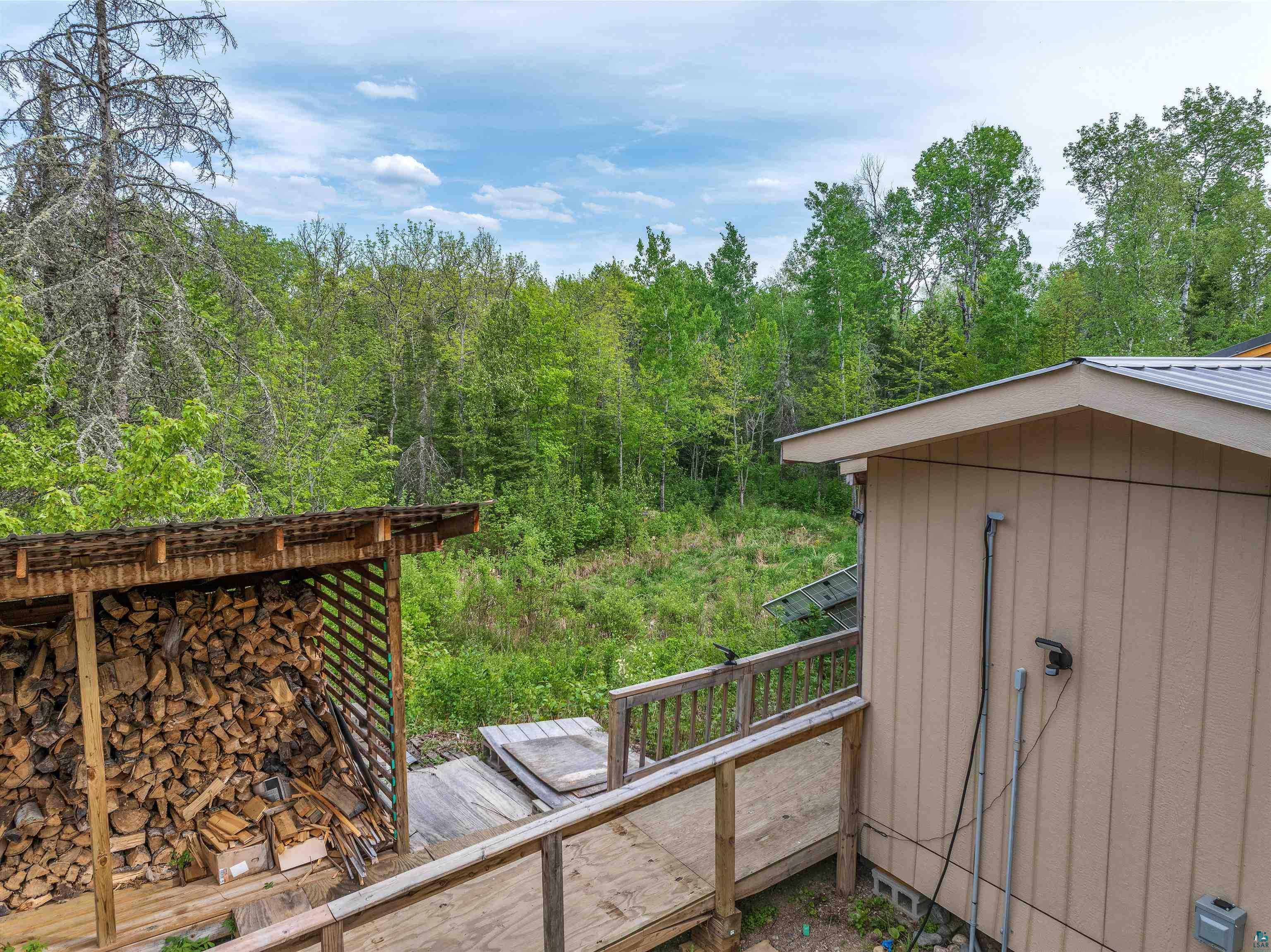 1152 Fernberg Road Ely, MN 55731 - Photo 21 of 24 Wood storage structure with a full woodpile