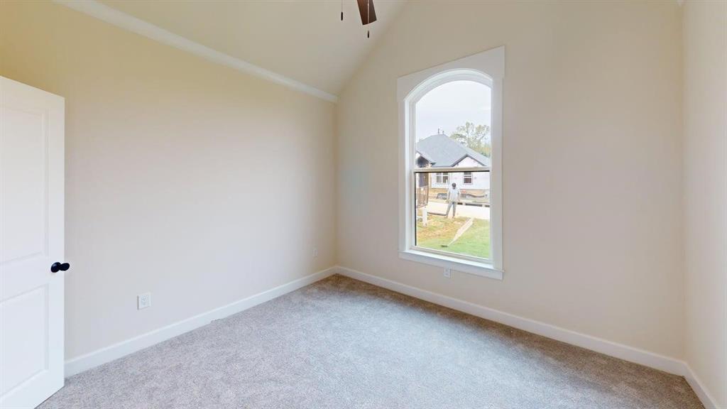 2509 Windmill Lane Longview, TX 75601 - Photo 20 of 35 Carpeted spare room with ceiling fan and vaulted ceiling
