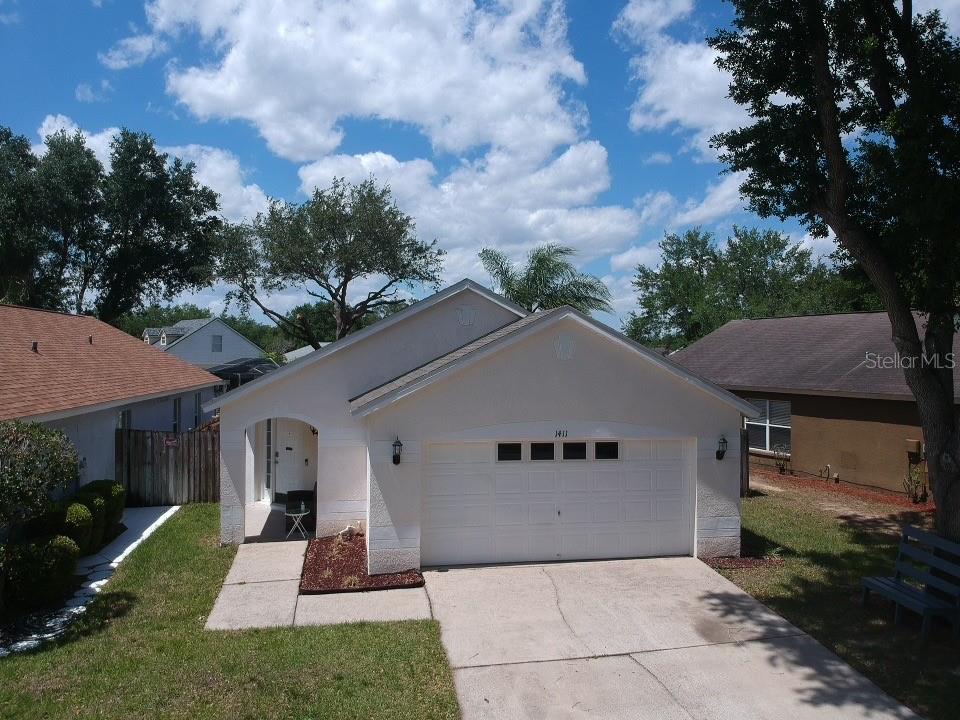 1411 Dew Bloom Road Valrico, FL 33594 - Photo 1 of 1 a front view of a house with a yard