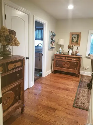 a room with a bed and a dresser in it