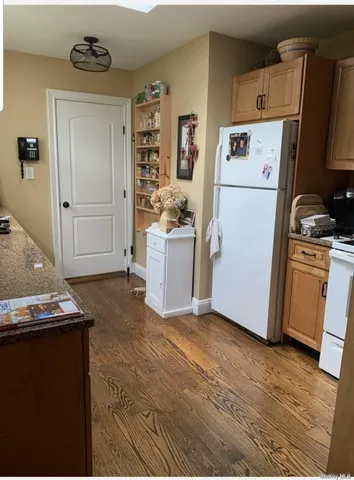 a kitchen with a refrigerator sink stove and cabinets
