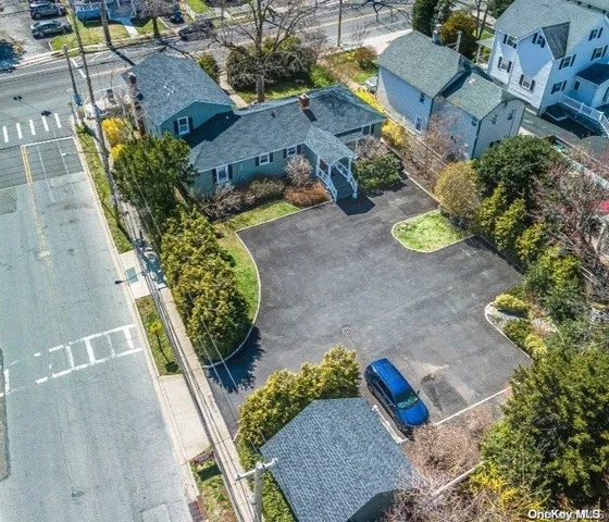 an aerial view of a house with a yard and sitting area