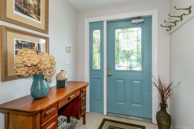 a view of a dining room with furniture and a window