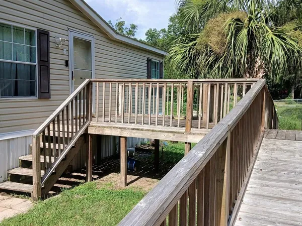 a view of balcony with wooden floor and white roof