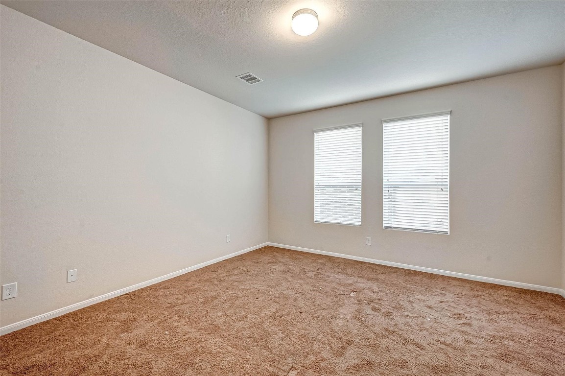 3322 Coopers Ridge Way Houston, TX 77084 - Photo 15 of 41 Spacious first floor primary suite with large windows and plenty of natural light.