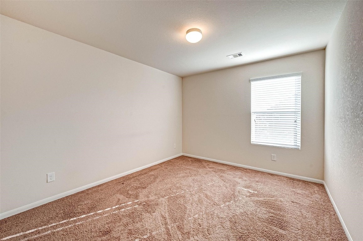 3322 Coopers Ridge Way Houston, TX 77084 - Photo 28 of 41 Spacious secondary bedroom with ample closet space.