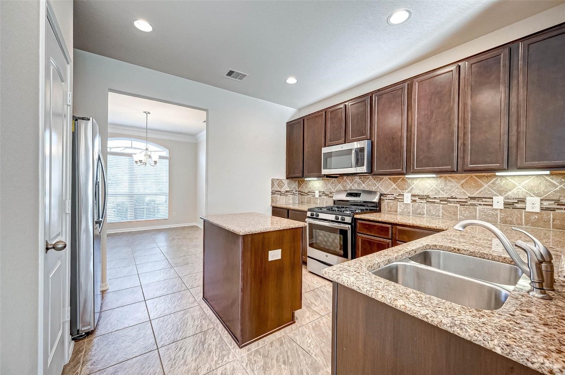 3322 Coopers Ridge Way Houston, TX 77084 - Photo 8 of 41 Bright and functional kitchen featuring ample cabinetry, generous counter space, and a convenient layout.