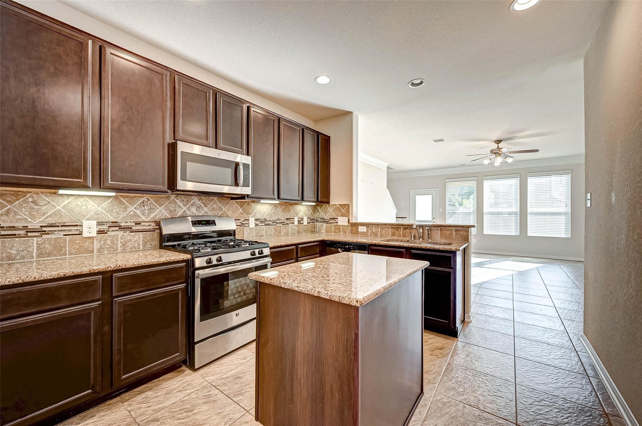 3322 Coopers Ridge Way Houston, TX 77084 - Photo 9 of 41 Open kitchen design overlooking the living area, ideal for gatherings.