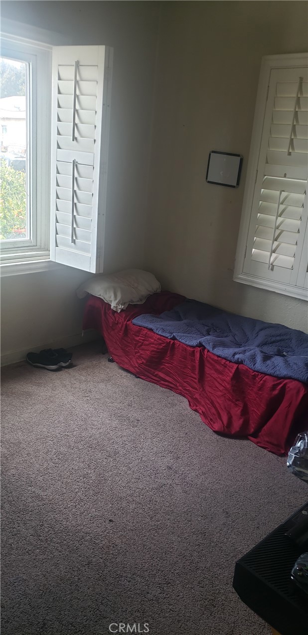 420 South Pearl Avenue Compton, CA 90221 - Photo 12 of 15 a living room with a bed