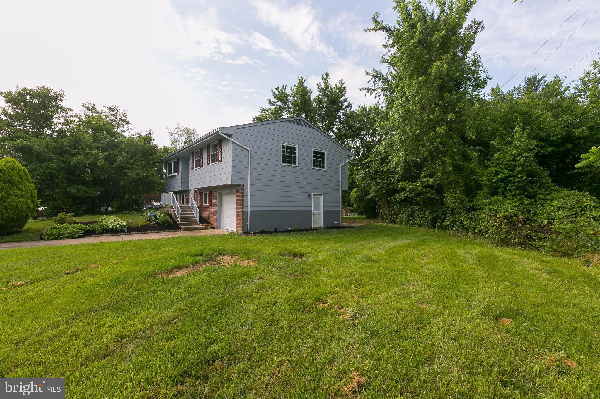 8621 Pilsen Road Randallstown, MD 21133 - Photo 2 of 26 a backyard of a house with plants and large tree