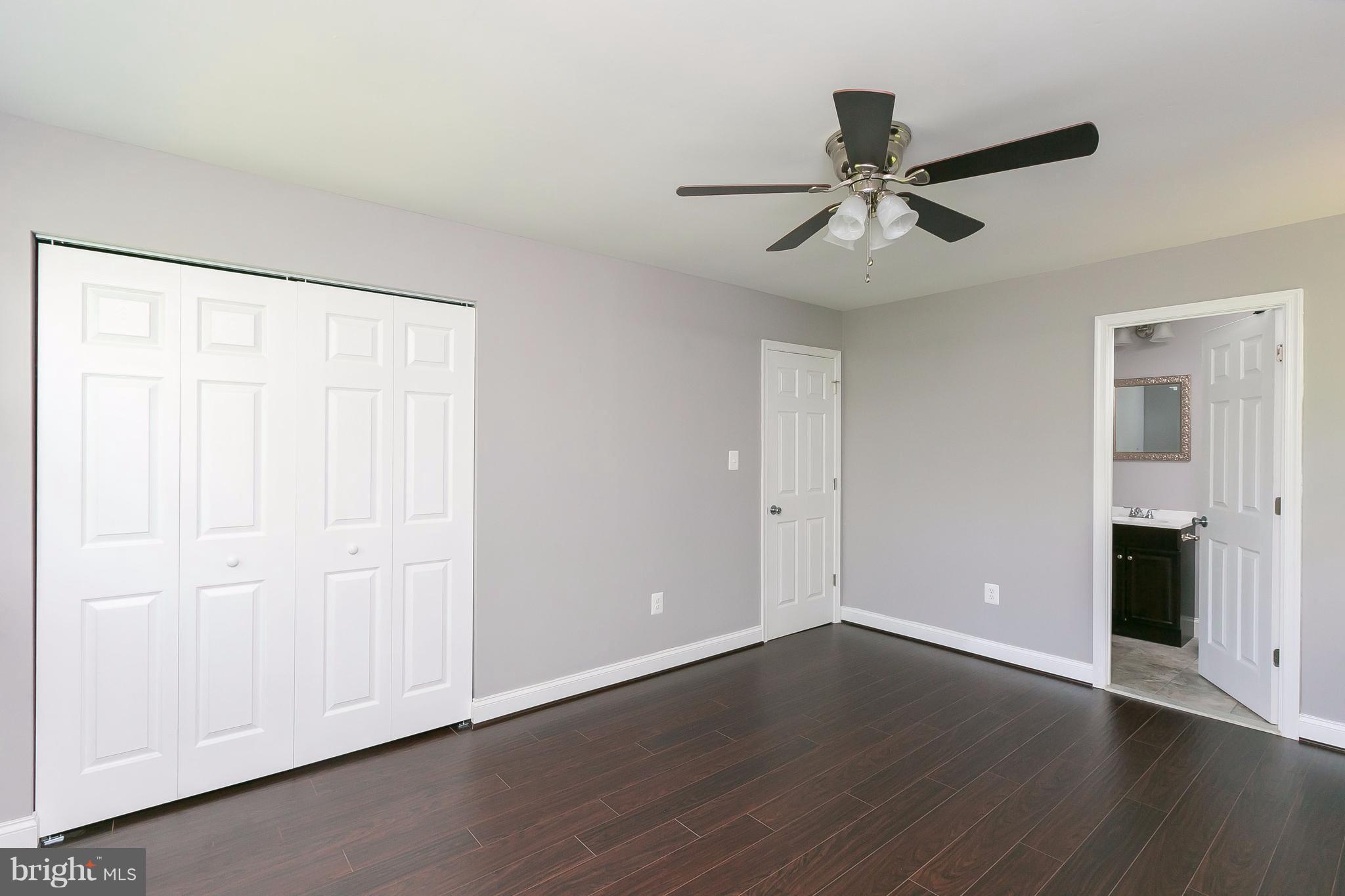 8621 Pilsen Road Randallstown, MD 21133 - Photo 12 of 26 an empty room with wooden floor closet and windows
