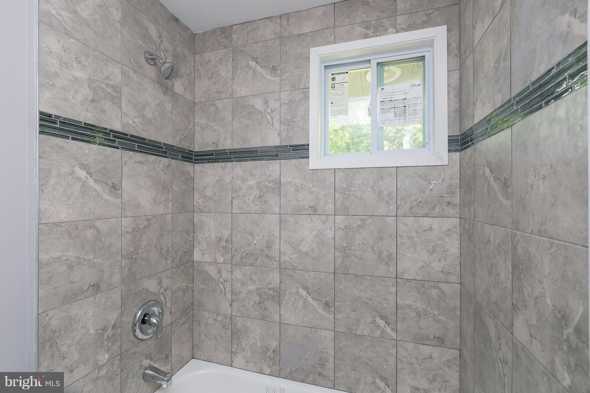 8621 Pilsen Road Randallstown, MD 21133 - Photo 14 of 26 a bathroom with a window and a shower