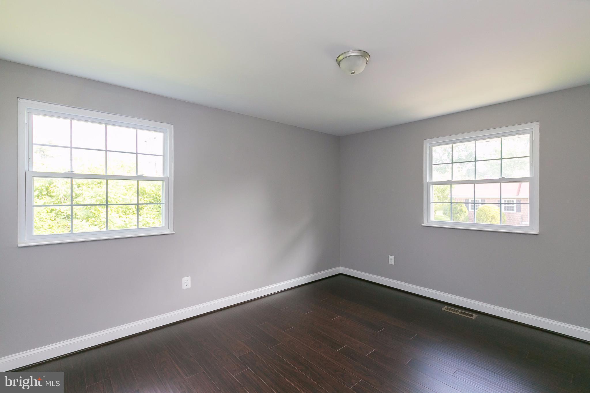 8621 Pilsen Road Randallstown, MD 21133 - Photo 15 of 26 an empty room with wooden floor and windows