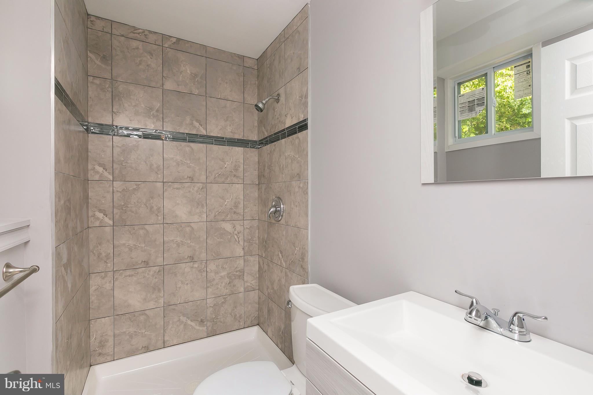 8621 Pilsen Road Randallstown, MD 21133 - Photo 22 of 26 a bathroom with a sink toilet and shower