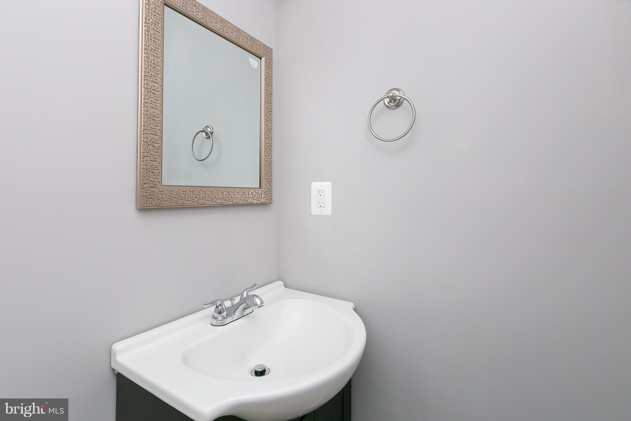 8621 Pilsen Road Randallstown, MD 21133 - Photo 10 of 26 a bathroom with a sink and mirror