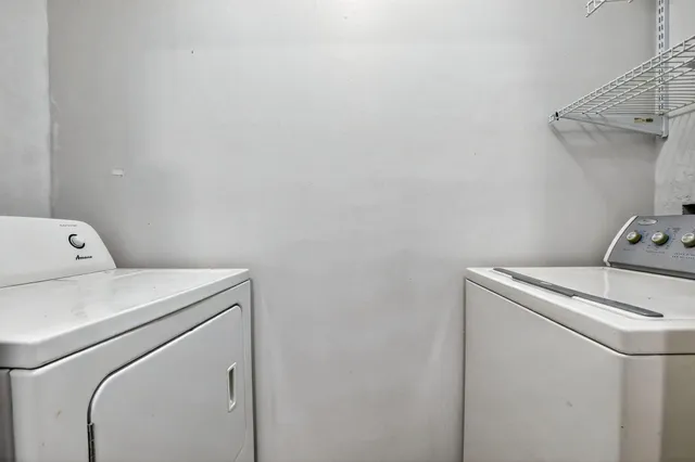 a kitchen with granite countertop stainless steel appliances a sink and a refrigerator