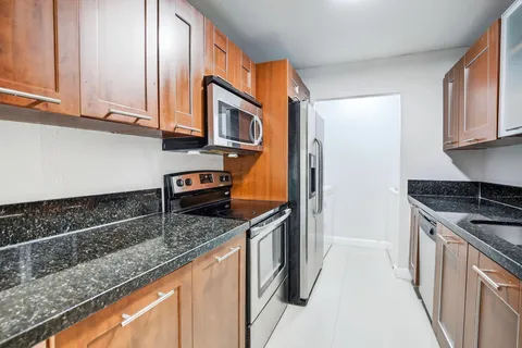 a kitchen with stainless steel appliances a refrigerator and a stove top oven