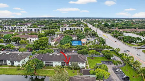 an aerial view of residential houses with outdoor space and trees