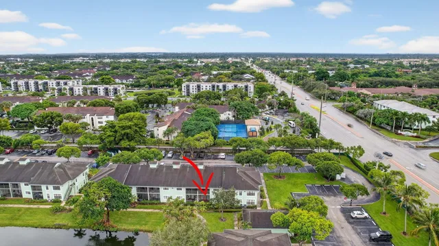 an aerial view of residential houses with outdoor space and trees