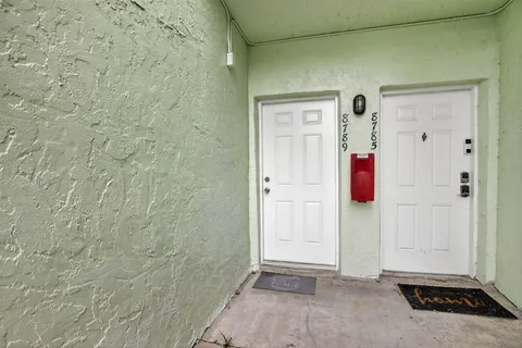 a view of a kitchen with a refrigerator and a sink
