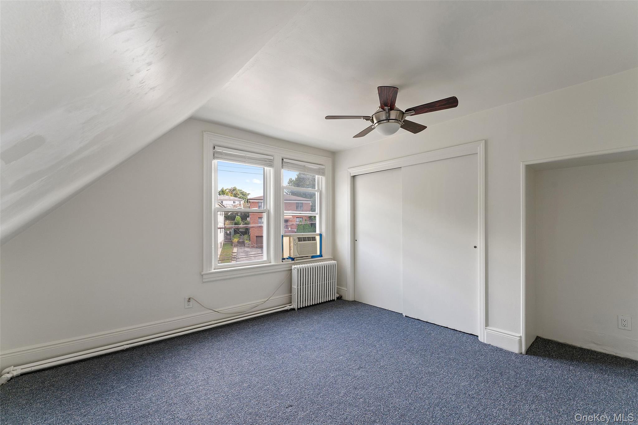 355 Bronxville Road Bronxville, NY 10708 - Photo 13 of 22 an empty room with chandelier fan and windows
