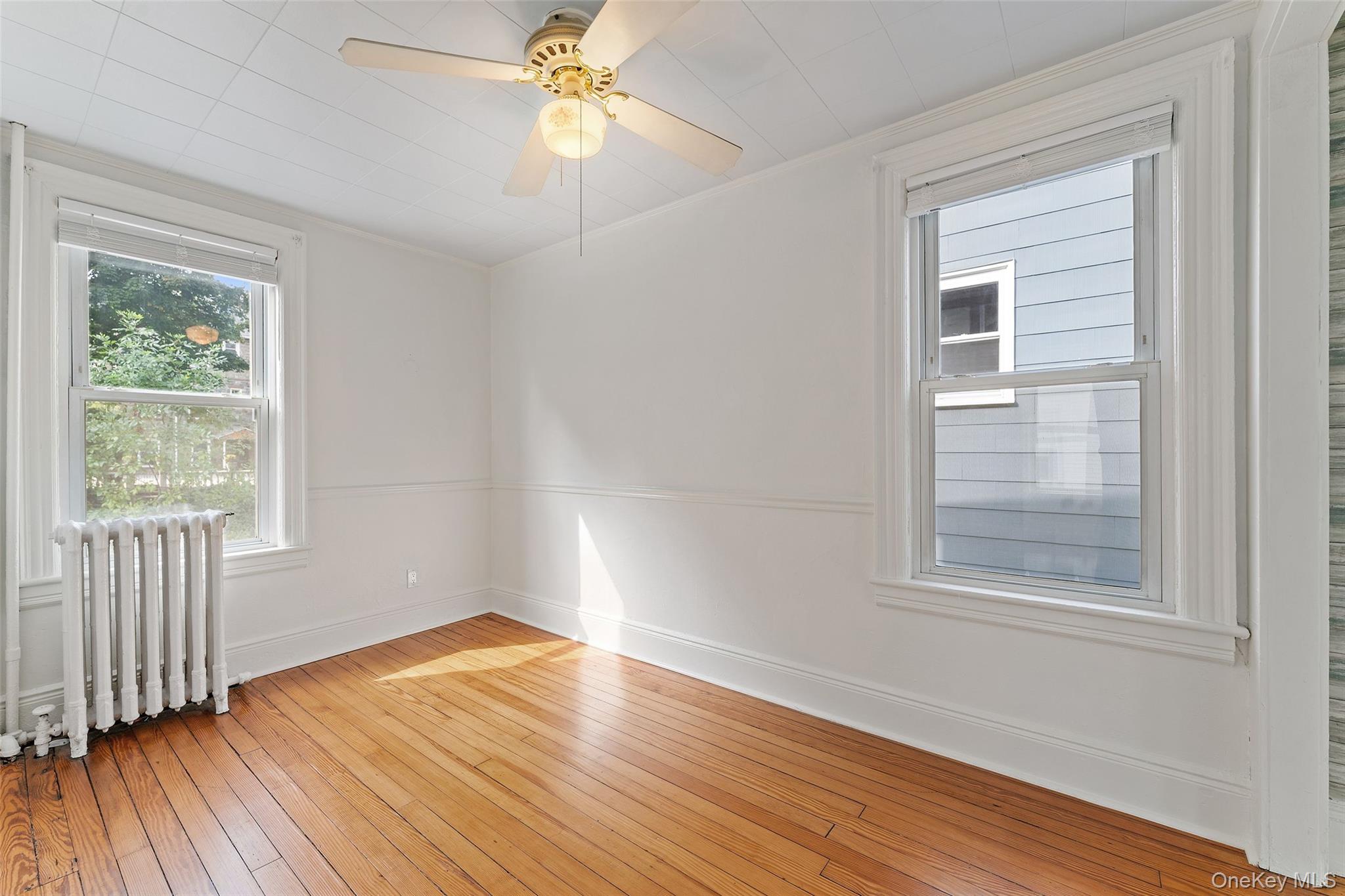 355 Bronxville Road Bronxville, NY 10708 - Photo 6 of 22 a view of an empty room with wooden floor and a window