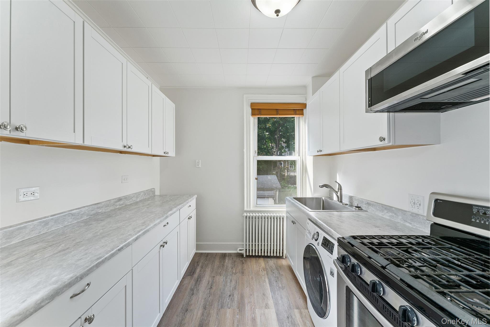 355 Bronxville Road Bronxville, NY 10708 - Photo 9 of 22 a kitchen with a sink stove top oven and cabinets