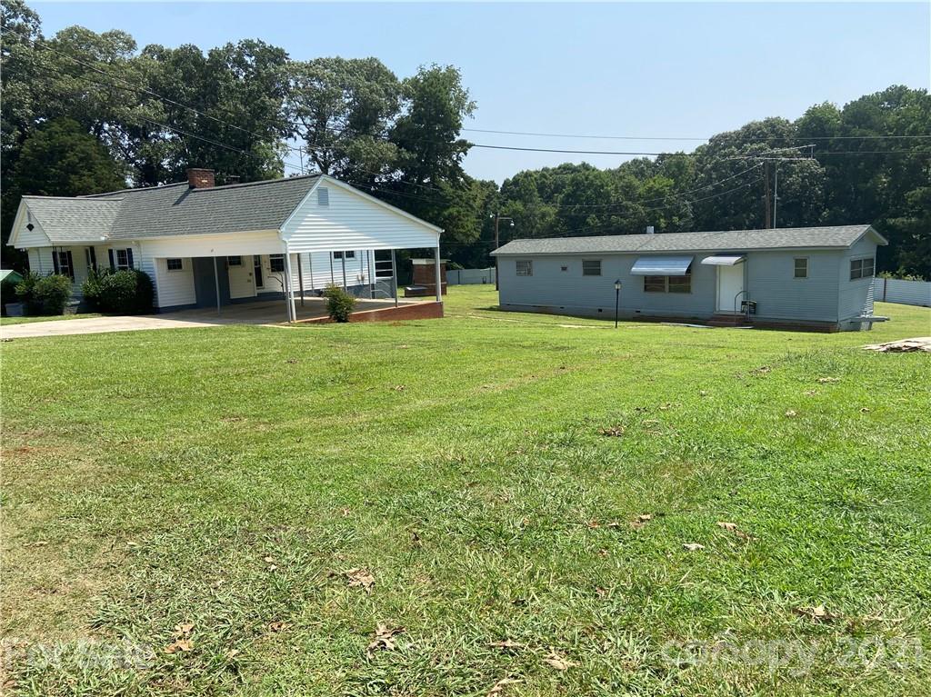 883 State Rd S-29-376 Lancaster, SC 29720 - Photo 1 of 16 a front view of a house with a garden