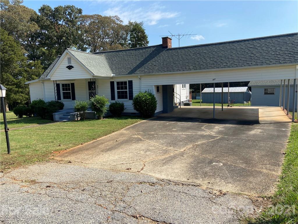 883 State Rd S-29-376 Lancaster, SC 29720 - Photo 13 of 16 a front view of a house with a yard and garage