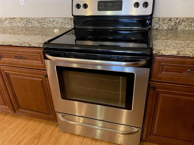 a stove top oven sitting inside of a kitchen