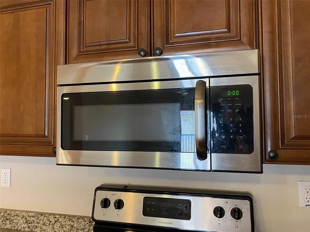 a kitchen with granite countertop stainless steel appliances and cabinets