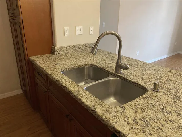 a view of a refrigerator in wooden floor