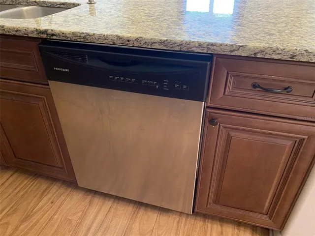 a view of a kitchen with a refrigerator and a sink