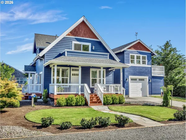 a front view of a house with a yard and potted plants