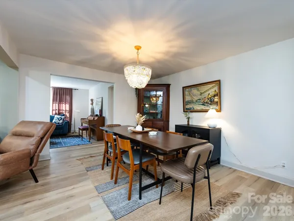 a view of a dining room with furniture and chandelier