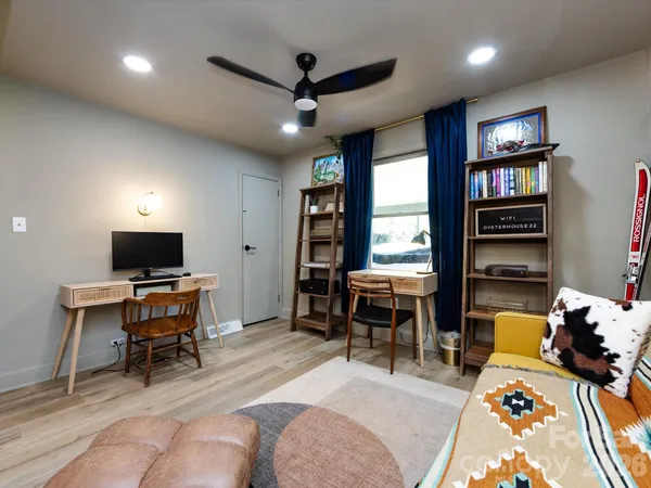 a living room with furniture a window and a flat screen tv