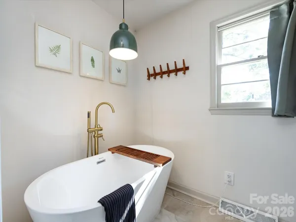 a bathroom with a sink a mirror and a shower