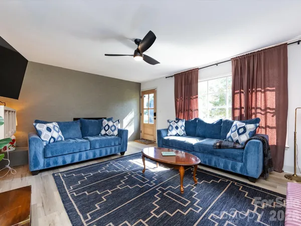 a living room with furniture and a flat screen tv
