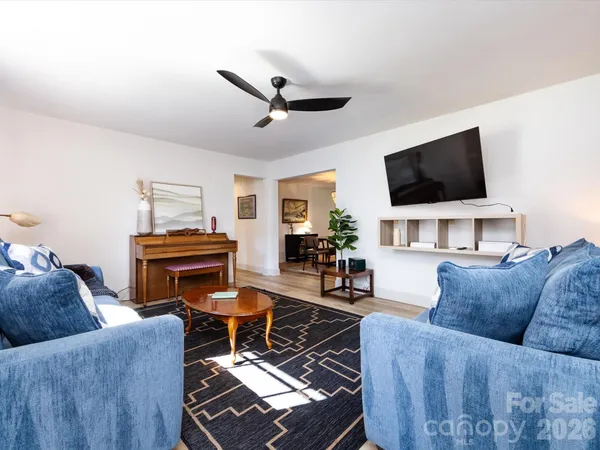 a living room with furniture and a flat screen tv