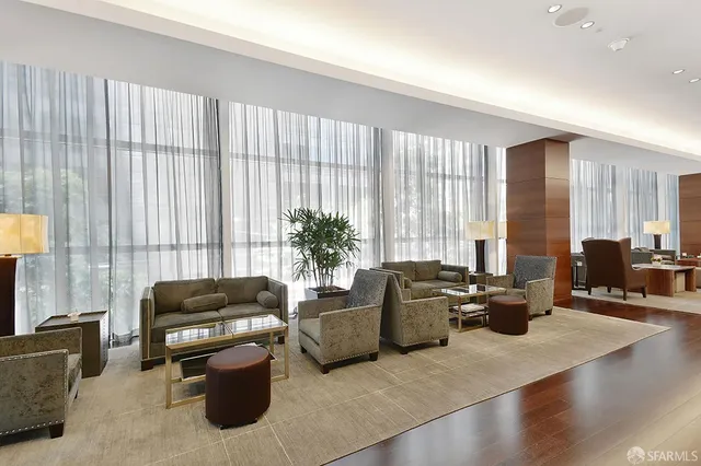 a living room with furniture and large windows